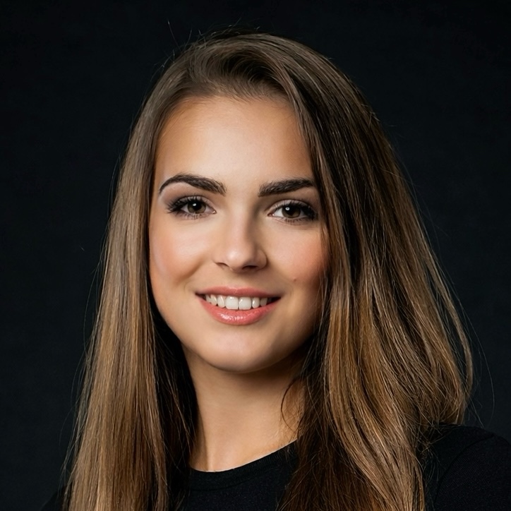 Anaida Bademian, UX/UI Designer. She has long brown hair, dark brown eyes and is wearing a white jacket