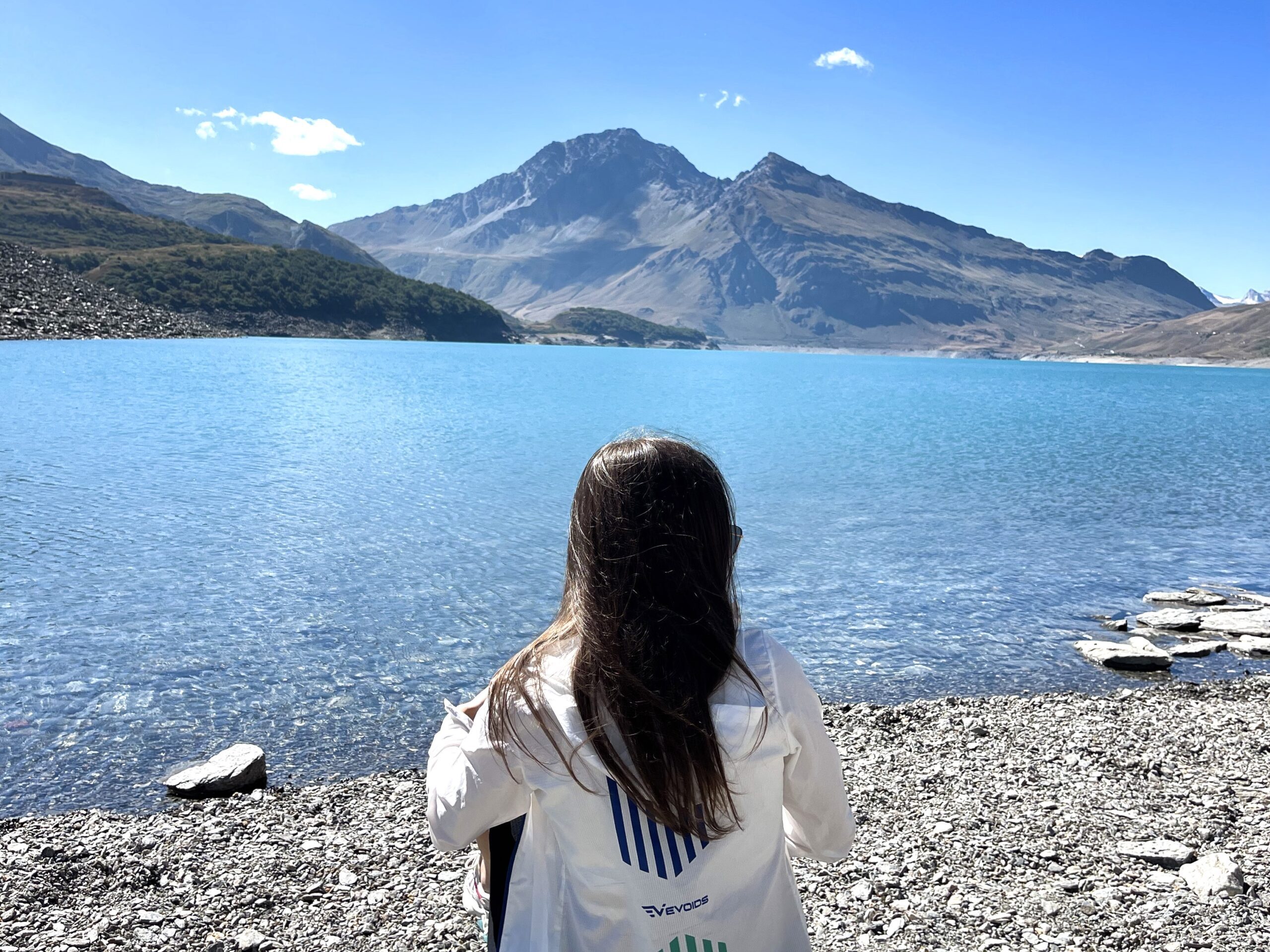 Anaida sits by a beautiful clear lake at the foot of a green-capped mountain